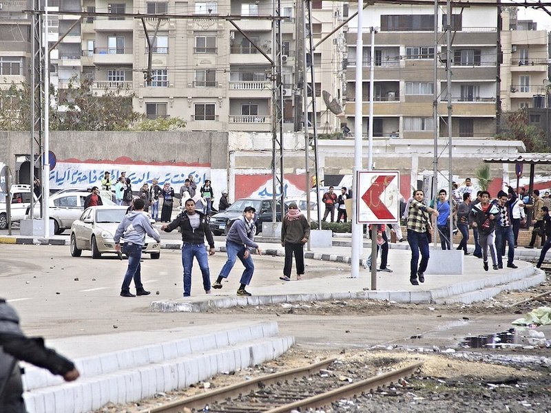 men_throwing_rocks_at_police_-_protest_al-azhar_university_cairo_20-dec-2013_1.jpg